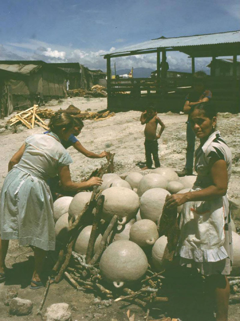 Several women working together to make clay pitchers