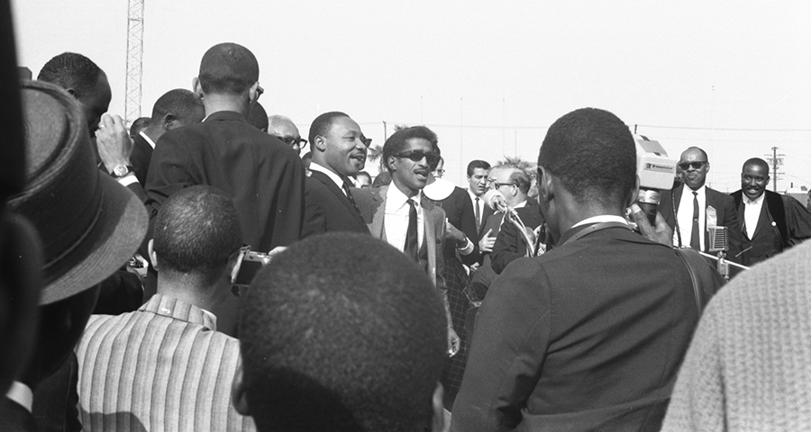 Men in a group standing outside at the Freedom rally.