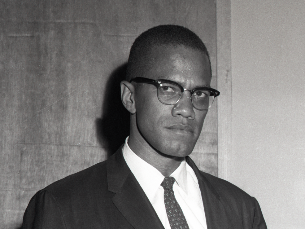 Portrait of person in suit and glasses