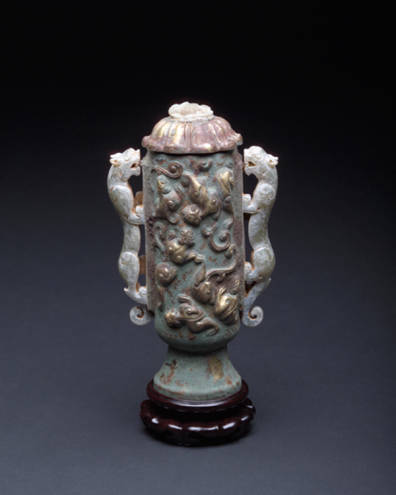Ritual vessel. Bronze body with gold dragons inlaid and carved jade handles. Gold flower cover with jade dragon inlays. Tin lined.