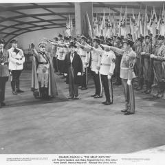 Film still showing men saluting Hitler from The Great Dictator