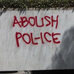 Graffiti on quartz wall: ABOLISH POL-ICE