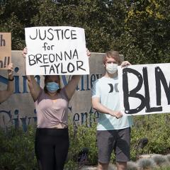 Four masked protesters in from of the Simi Valley Civic Center sign, holding signs: Enough is Enough!!; JUSTICE for BREONNA TAYLOR; BLM