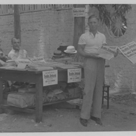 Photograph of men selling newspapers at Hindenburg Park