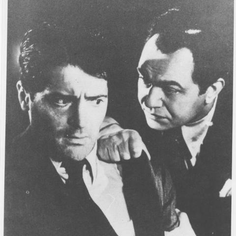 Photograph of one man addressing another man