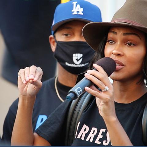 Woman speaks through handheld microphone