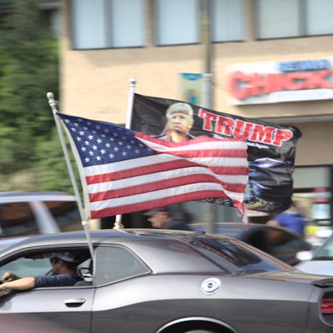 Car decorated with large Trump and American flags.