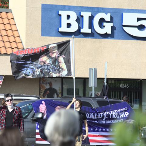 Demonstrators wave American and Trump flags