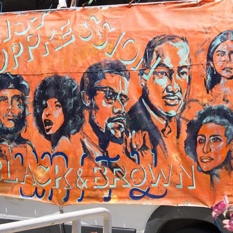Banner featuring civil rights leaders and activists: RESIST OPPRESSION BLACK & BROWN