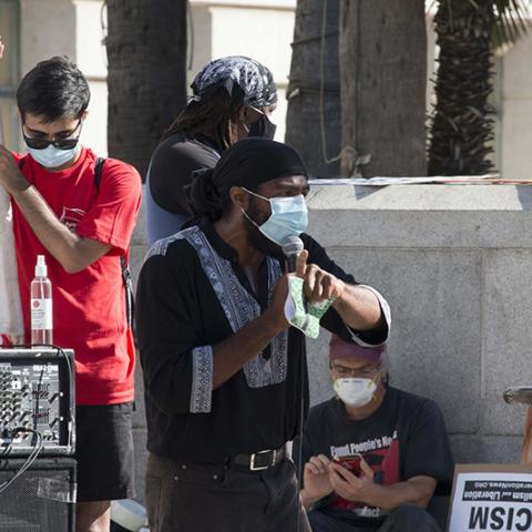Masked speaker speaking through microphone