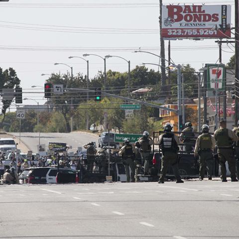 A group of law enforcement stand near  protesters