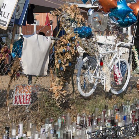 Memorial to Dijon Kizee with a bicycle, balloons, flowers and candles