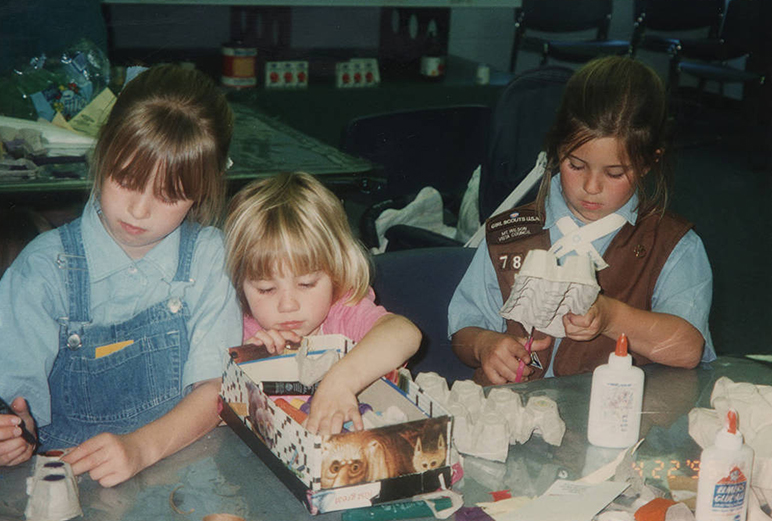 Three children working on various arts and crafts