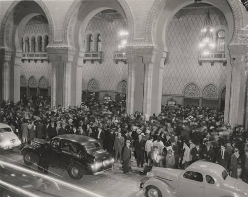 Crowd of people standing outside a building