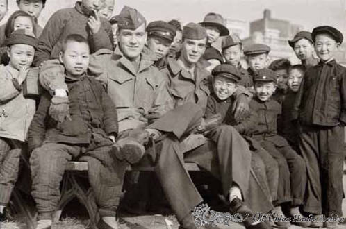 American enlisted men with a crowd of local children in Tientsin park